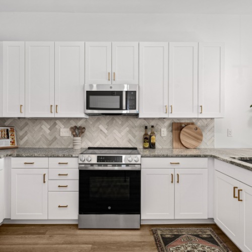 Stylish tiled backsplash and stainless steel appliances